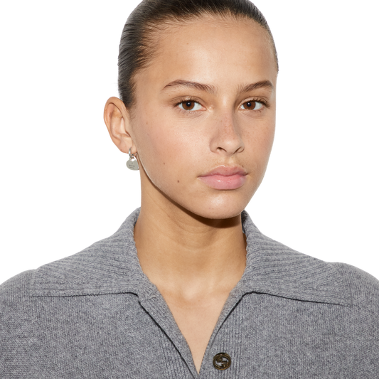 These Gucci sterling silver drop earrings showcase the brand’s romantic Trademark heart design, complete with a smaller cut-out heart detail within the pendant. Finished with a polished shine and engraved branding, they offer a balance of subtle sophistication and contemporary designer appeal.