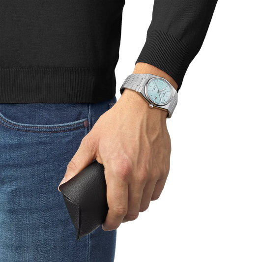 Tissot PRX automatic watch featuring an ice blue dial and integrated stainless steel bracelet.