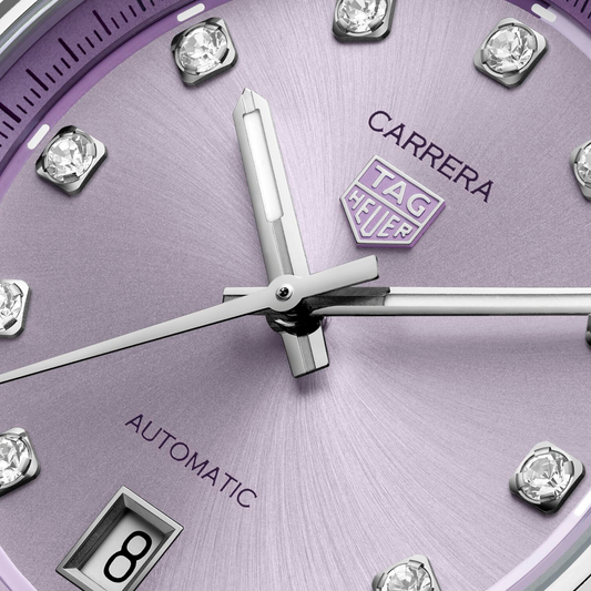 close-up of the lavender dial highlighting the sunray finish, diamond hour markers, applied logo and refined handset