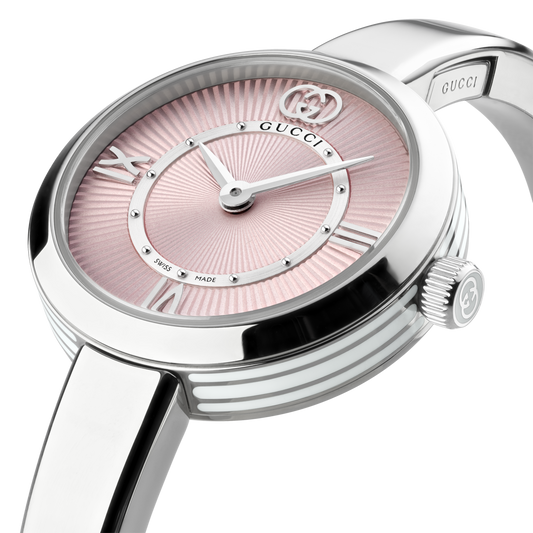 side profile of the Gucci watch highlighting the polished stainless steel bangle bracelet, rounded case shape, and crown detailing