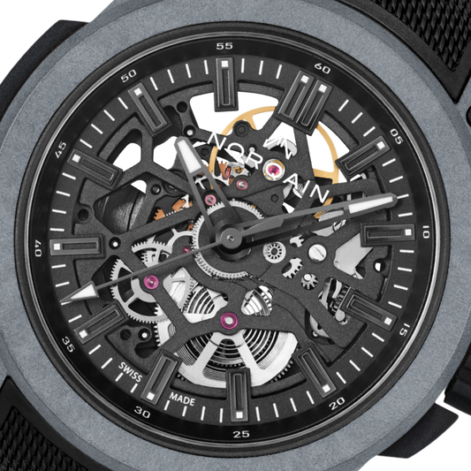 Close-up of the Norqain skeleton dial sports watch showcasing exposed mechanical components, monochrome grey detailing, lightweight case construction and modern technical styling.