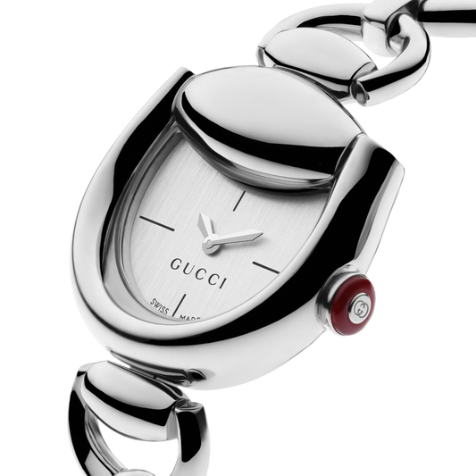 Angled view of the Gucci Horsebit watch highlighting its sculpted case and silver dial.