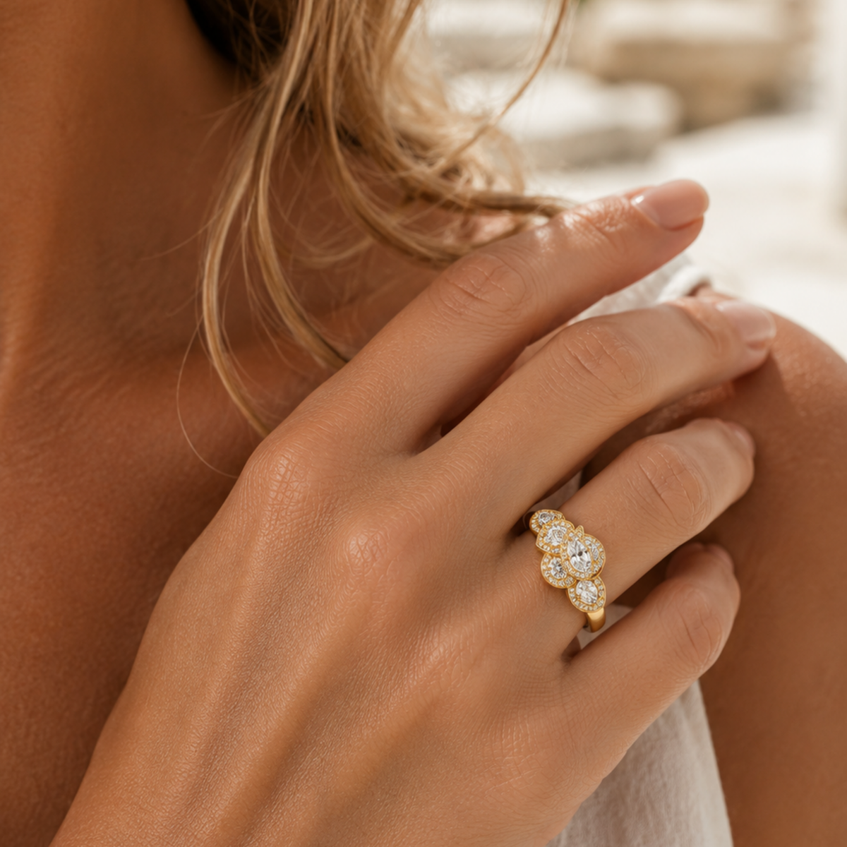 Model wearing the Pear Cut Cluster Ring in 18ct Yellow Gold showcasing its elegant diamond cluster design.