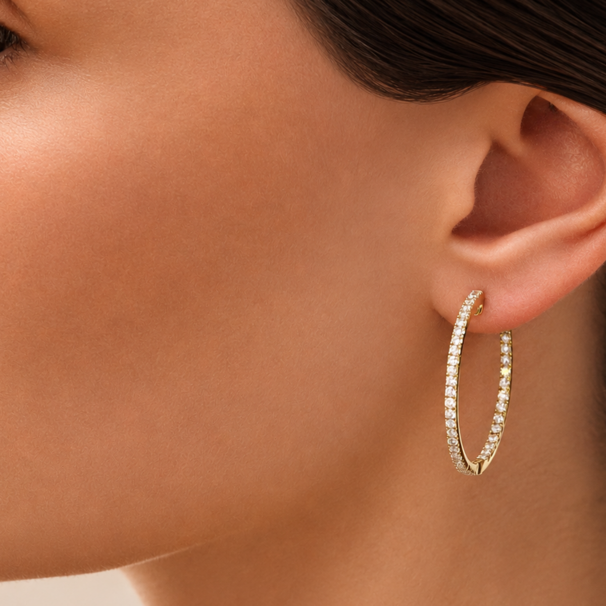 A Lister Horsfall Modal wearing Brilliant Cut Diamond Hoop Earrings in 18ct Yellow Gold