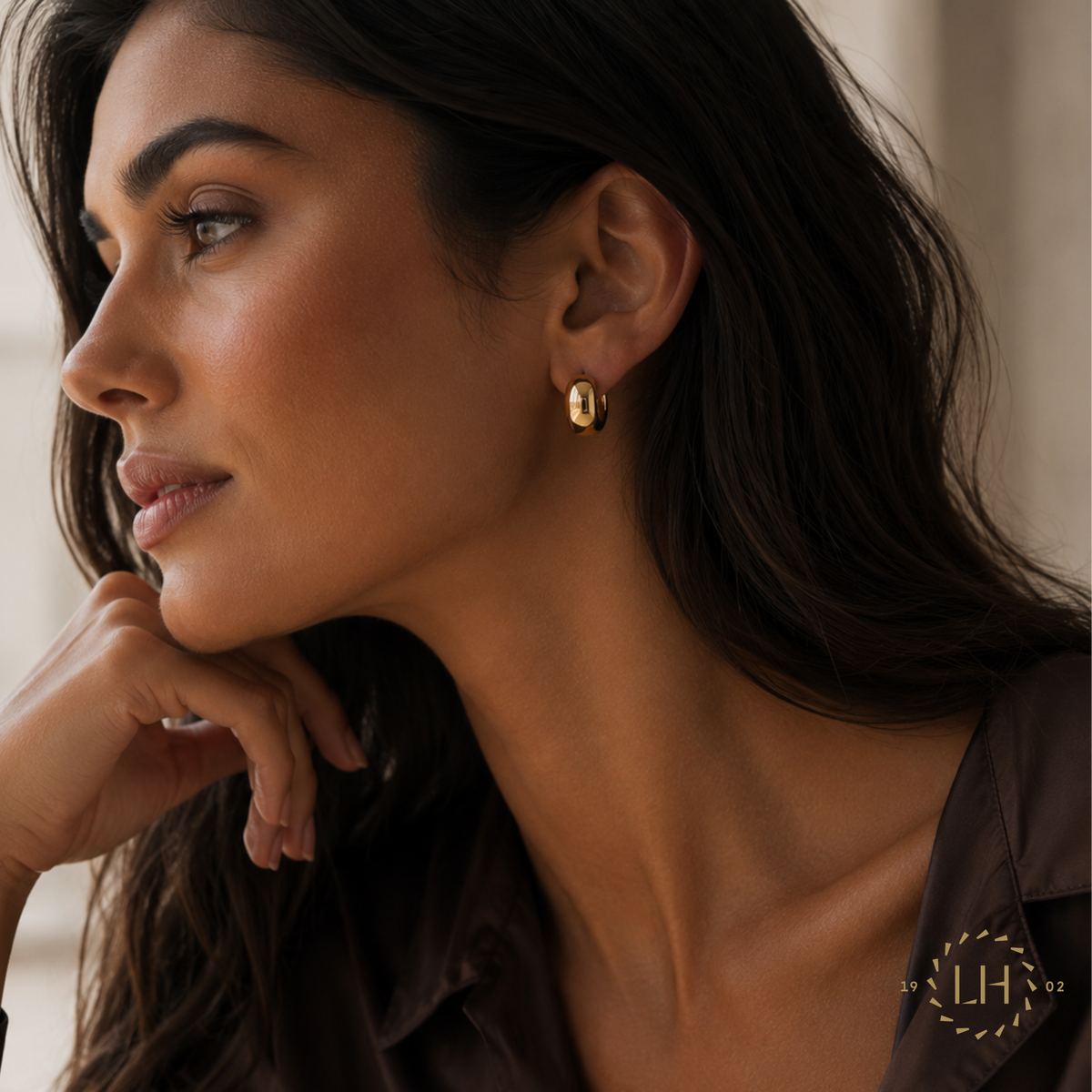 A Model Showcasing the 12mm Hoop Earrings in 18ct Yellow Gold from Lister Horsfall Jewellery.