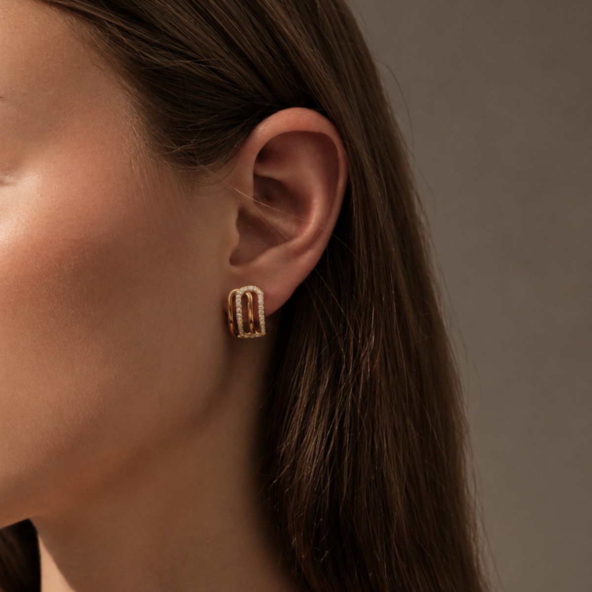 Diamond Oval Open Stud Earrings in 18ct Rose Gold on Transparent Background on a Modal With a Low Bun 