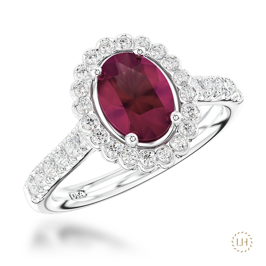 Rich in colour and beautifully detailed, this Platinum Ruby and Diamond Cluster Ring showcases a captivating 1.04ct ruby at the heart of its design.
