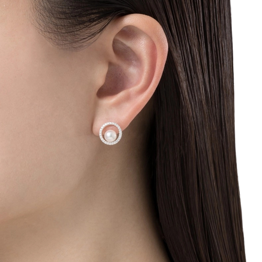 Crafted from luxurious 18ct white gold, the refined circular design creates an elegant frame around each luminous pearl.