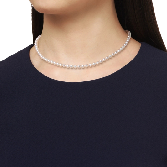 Mikimoto M Code Necklace, featuring luminous 5mm Akoya cultured pearls with a distinctive 18ct yellow gold chain clasp on a modal 