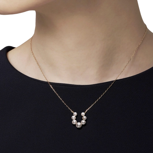 A model wearing Mikimoto Bubble Akoya Cultured Pearl and Diamond Pendant in 18ct Yellow Gold