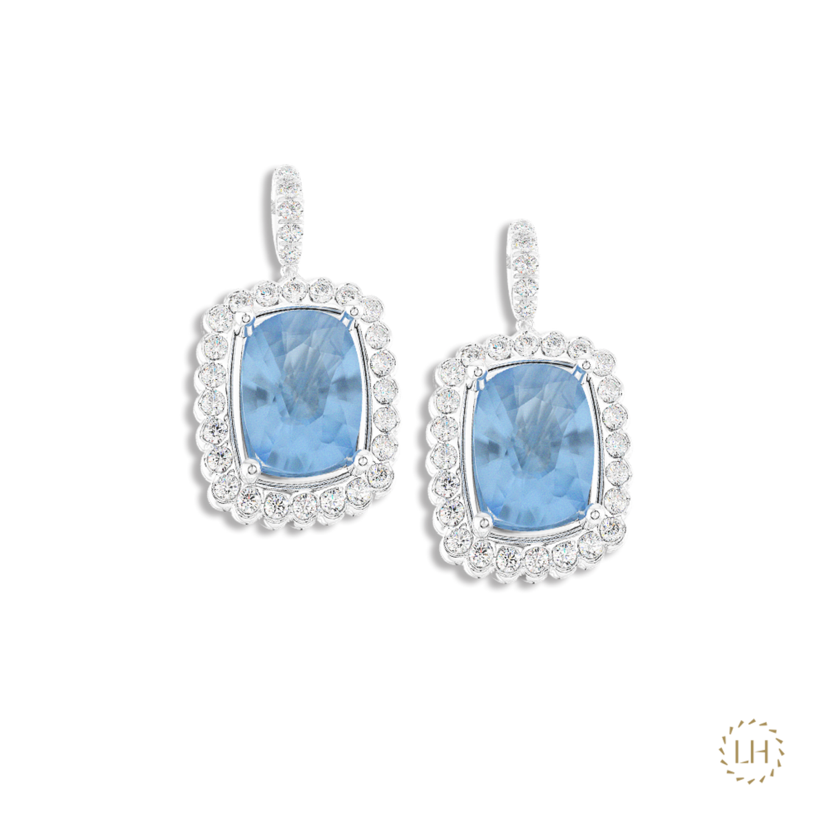 Discover these Platinum Aquamarine & Diamond Drop Earrings, featuring 3.89ct of cushion-cut aquamarines surrounded by 0.55ct of sparkling diamonds.