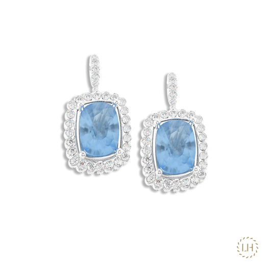 Discover these Platinum Aquamarine & Diamond Drop Earrings, featuring 3.89ct of cushion-cut aquamarines surrounded by 0.55ct of sparkling diamonds.