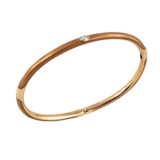 Warm tones and contemporary design come together in this 18ct yellow gold Populse Cappuccino bangle, featuring a 0.14ct brilliant round diamond and a rich partial brown enamel finish.
