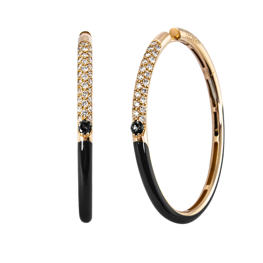 A striking blend of brilliance and contrast, these 18ct yellow gold Populse Glam hoop earrings feature 0.54ct of brilliant round diamonds, accented by a single 0.15ct black diamond and finished with sleek black enamel.