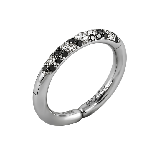 A striking mix of light and dark, this 18ct white gold Populse Jungle Black & White ring features a 0.22ct brilliant round diamond at its centre, with a beautifully scattered blend of white and black diamonds flowing along the half eternity band.