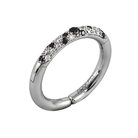 A bold contrast of colour and brilliance, this 18ct white gold Populse Jungle Black & White ring centres on a striking black diamond, with brilliant white and black diamonds scattered across the half eternity band.
