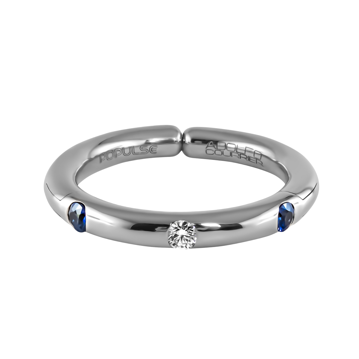 From the Populse Jeans Collection, this 18ct white gold design pairs a radiant centre diamond with two deep blue sapphires, creating a clean, modern silhouette with timeless appeal.