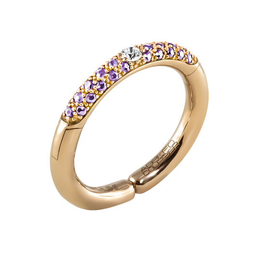 Soft lilac hues meet timeless brilliance in this 18ct yellow gold Populse Lilla ring, featuring a 0.09ct brilliant round diamond surrounded by a shimmering half eternity of lilac sapphires.