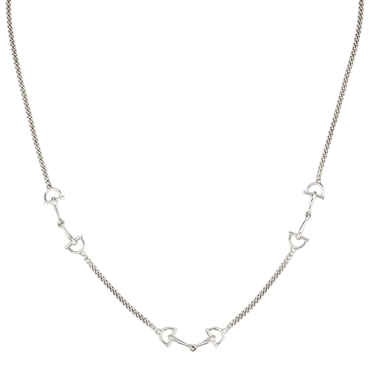 Close-up of the Gucci Staffa sterling silver necklace showcasing the polished stirrup-inspired motifs connected by a fine silver chain.