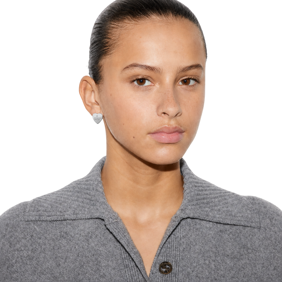 Model wearing the Gucci Trademark stud heart earrings in 925 sterling silver.