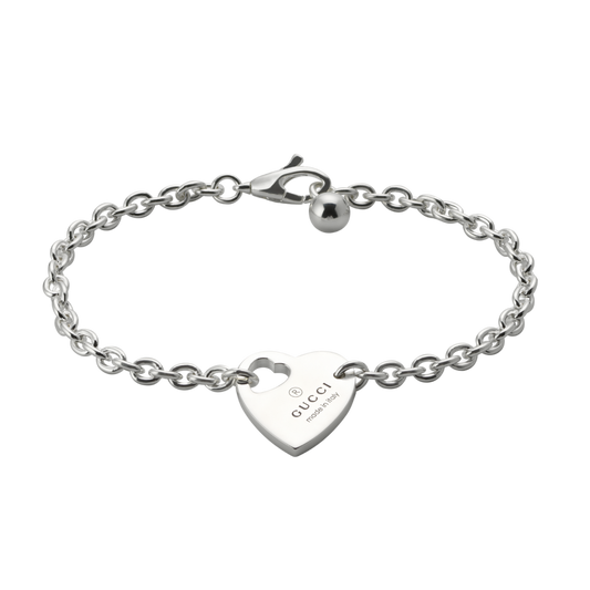 A romantic expression of Gucci’s signature design language, this Trademark heart motif bracelet is crafted from polished sterling silver and features an engraved heart charm with the iconic Gucci logo.