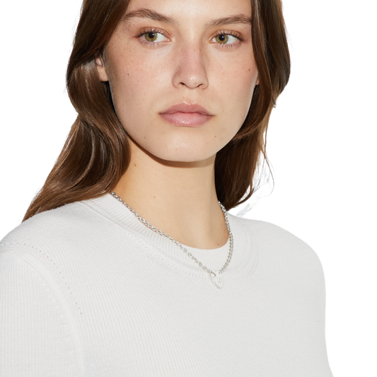 This Gucci sterling silver necklace showcases the house’s Trademark heart motif in a clean, elegant design. The polished heart pendant is engraved with the Gucci logo, creating a refined statement that balances sentimentality with modern Italian craftsmanship. Perfect for layering or wearing alone for understated designer style.