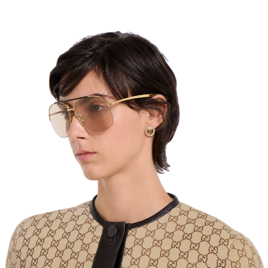 Gucci Horsebit earrings in 18ct yellow gold with brilliant round diamonds on model.