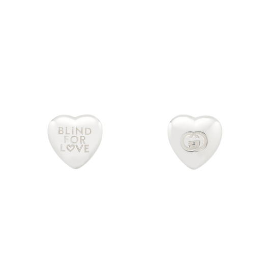 Elegant Gucci silver heart stud earrings with the iconic Blind For Love engraving, combining contemporary Italian design with timeless sterling silver craftsmanship.