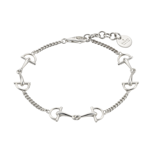Gucci Staffa bracelet in polished 925 sterling silver featuring five articulated stirrup-inspired motifs connected by a fine chain with an adjustable lobster clasp.