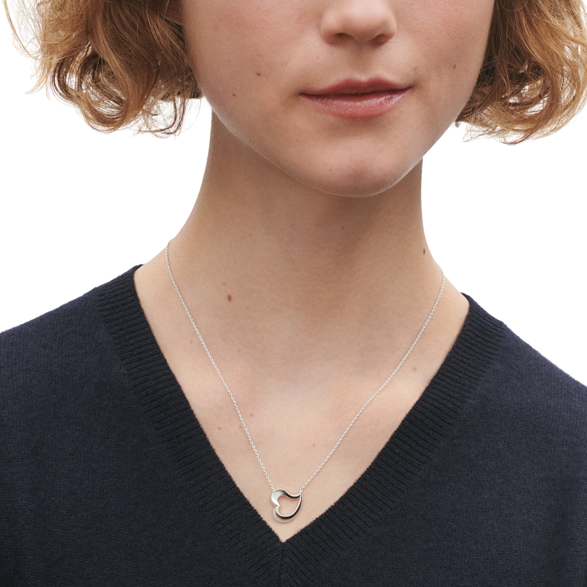The Georg Jensen Love Leaf Heart Necklace is a beautifully modern interpretation of the universal symbol of love. Crafted in sterling silver, the pendant features an elegant leaf-inspired shape that flows effortlessly into an asymmetrical heart, creating a design that feels both contemporary and timeless.