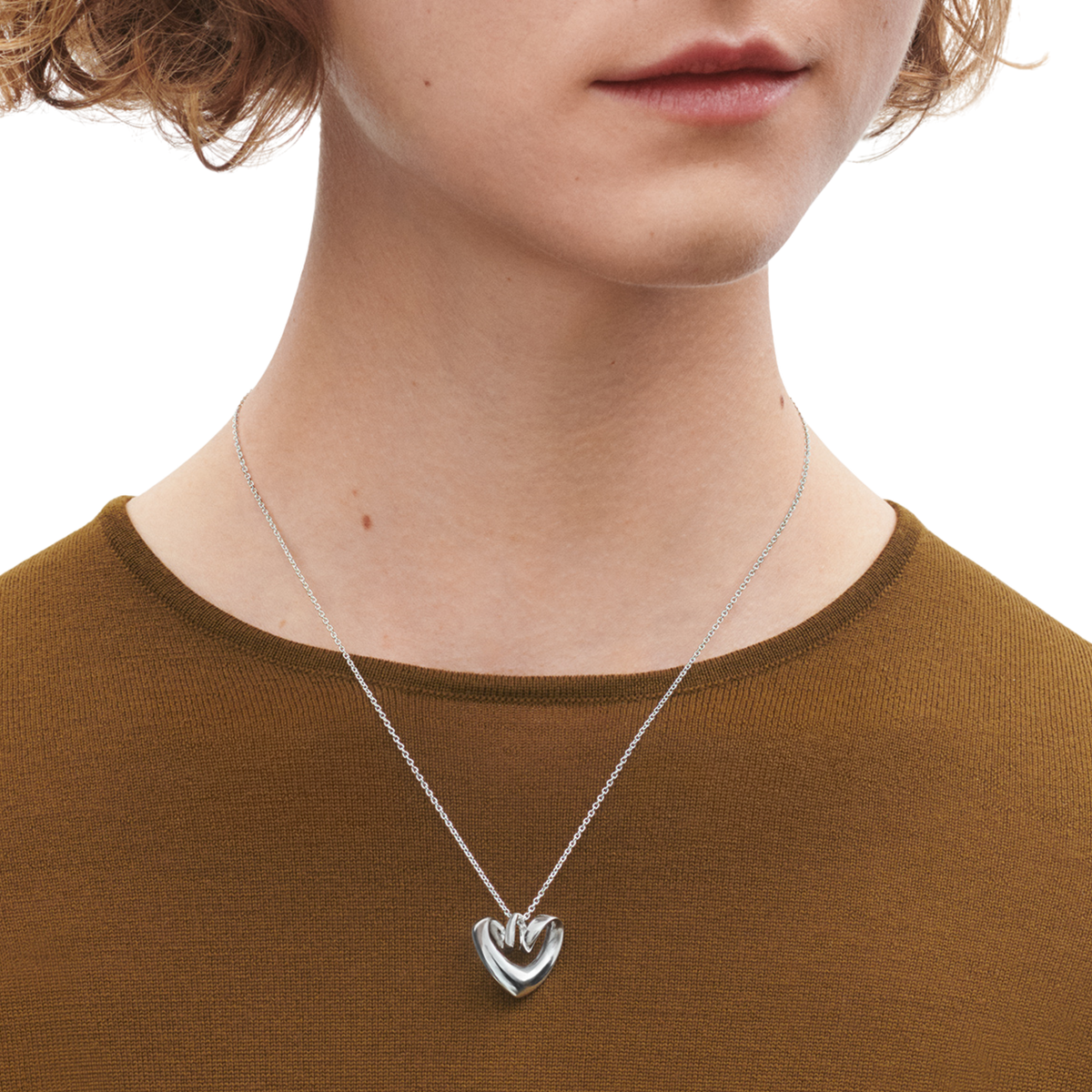 Designed to capture the essence of affection and connection, the heart-shaped pendant features smooth, organic lines that reflect light beautifully from every angle. Understated yet distinctive, it embodies the effortless sophistication for which Georg Jensen is renowned.