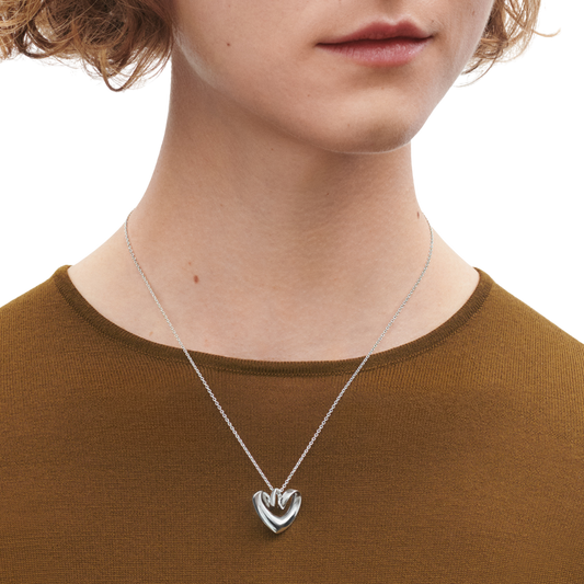 Designed to capture the essence of affection and connection, the heart-shaped pendant features smooth, organic lines that reflect light beautifully from every angle. Understated yet distinctive, it embodies the effortless sophistication for which Georg Jensen is renowned.