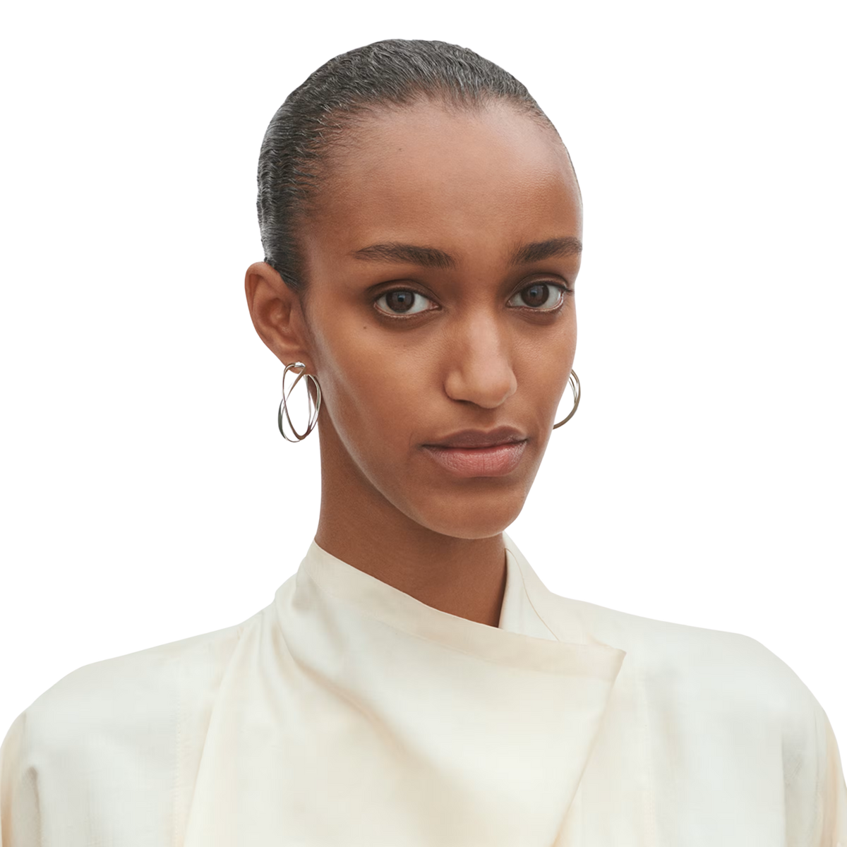 Designed by Regitze Overgaard, these Infinity Large Hoop Earrings are crafted in polished sterling silver, combining sculptural beauty with timeless Scandinavian style.