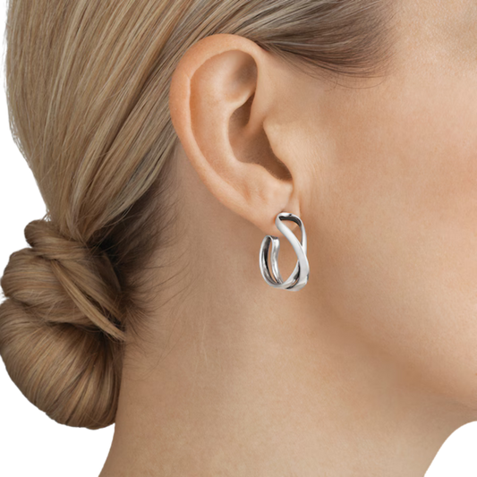 Designed by Regitze Overgaard, these sterling silver Infinity Hoop Earrings combine sculptural organic lines with timeless simplicity for effortless everyday elegance.