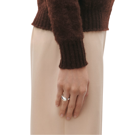 Smooth, polished, and beautifully proportioned, the Mercy Large Ring showcases the beauty of simplicity. Its flowing curves create a natural sense of movement, drawing the eye from every angle and giving the piece a distinctive character that sets it apart from more conventional jewellery designs.