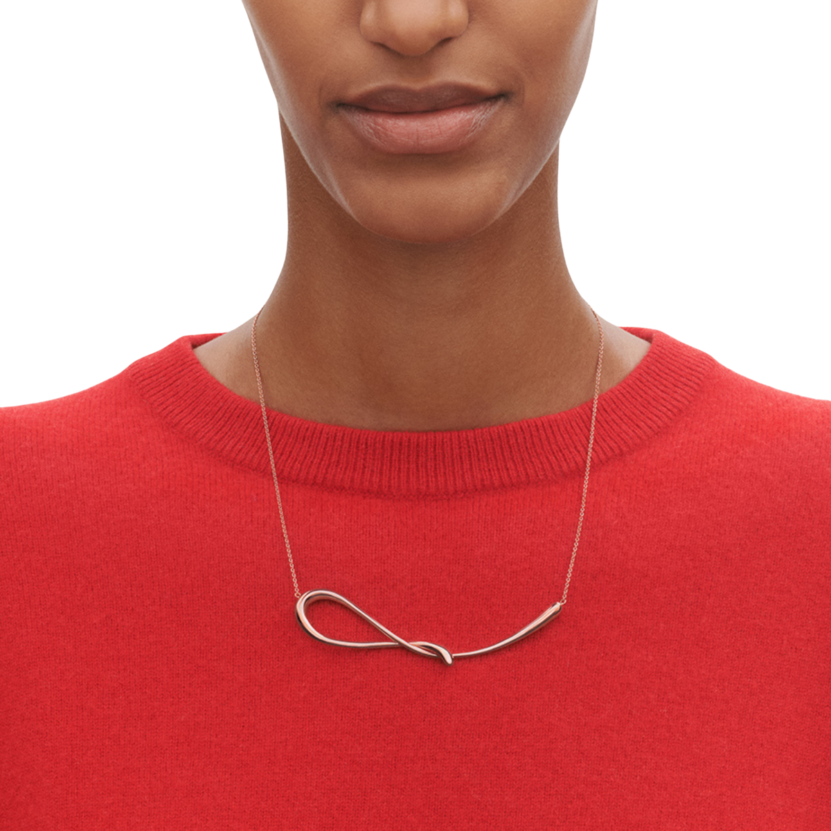 Unlike a traditional pendant, the Mercy design follows a soft, organic curve that sits beautifully against the neckline. The polished silver finish reflects the light naturally, giving the piece a subtle shine without feeling overly formal.