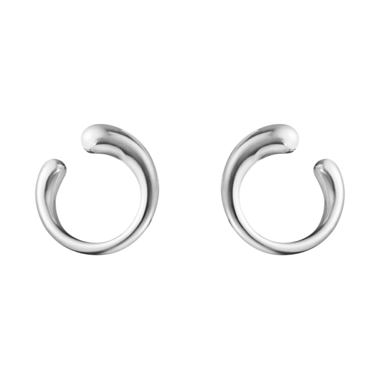 The Georg Jensen Mercy Silver Earring is a striking example of contemporary Scandinavian design, featuring a fluid, organic shape that gracefully follows the natural curve of the ear. 