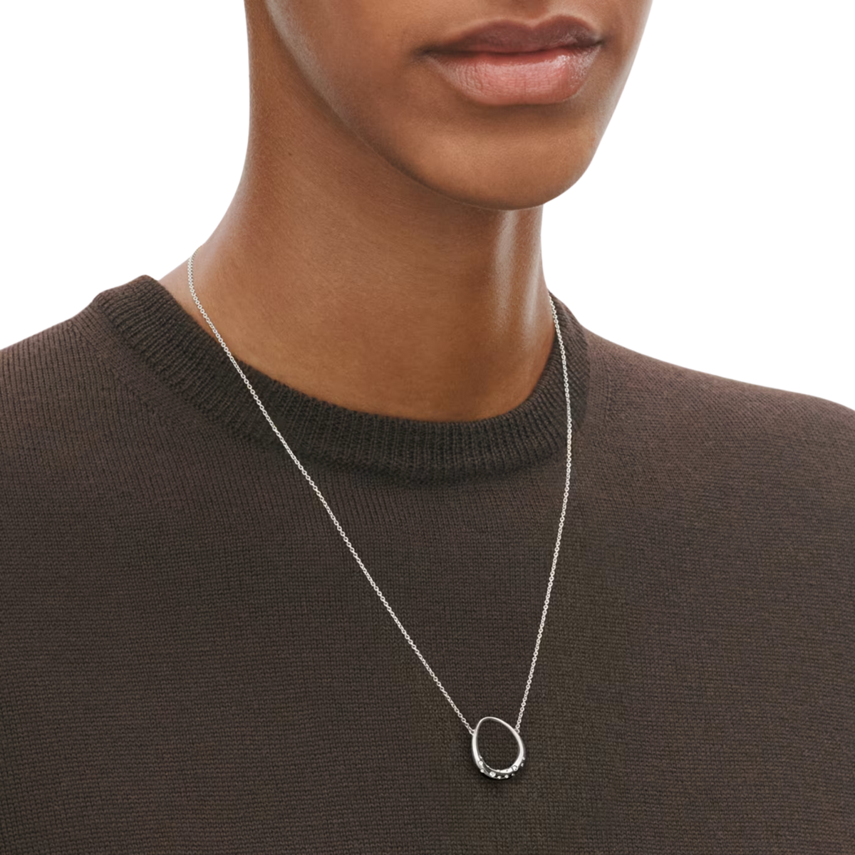 Crafted in sterling silver, the softly rounded pendant is finished with a sparkling diamond that adds a subtle touch of luxury to this beautifully understated piece.