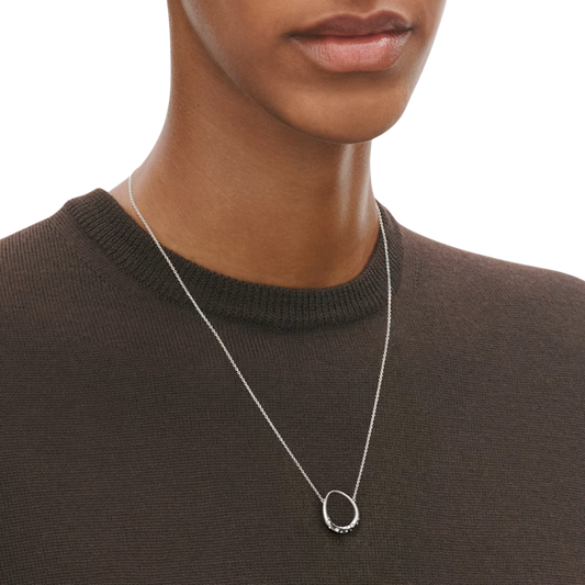 Crafted in sterling silver, the softly rounded pendant is finished with a sparkling diamond that adds a subtle touch of luxury to this beautifully understated piece.