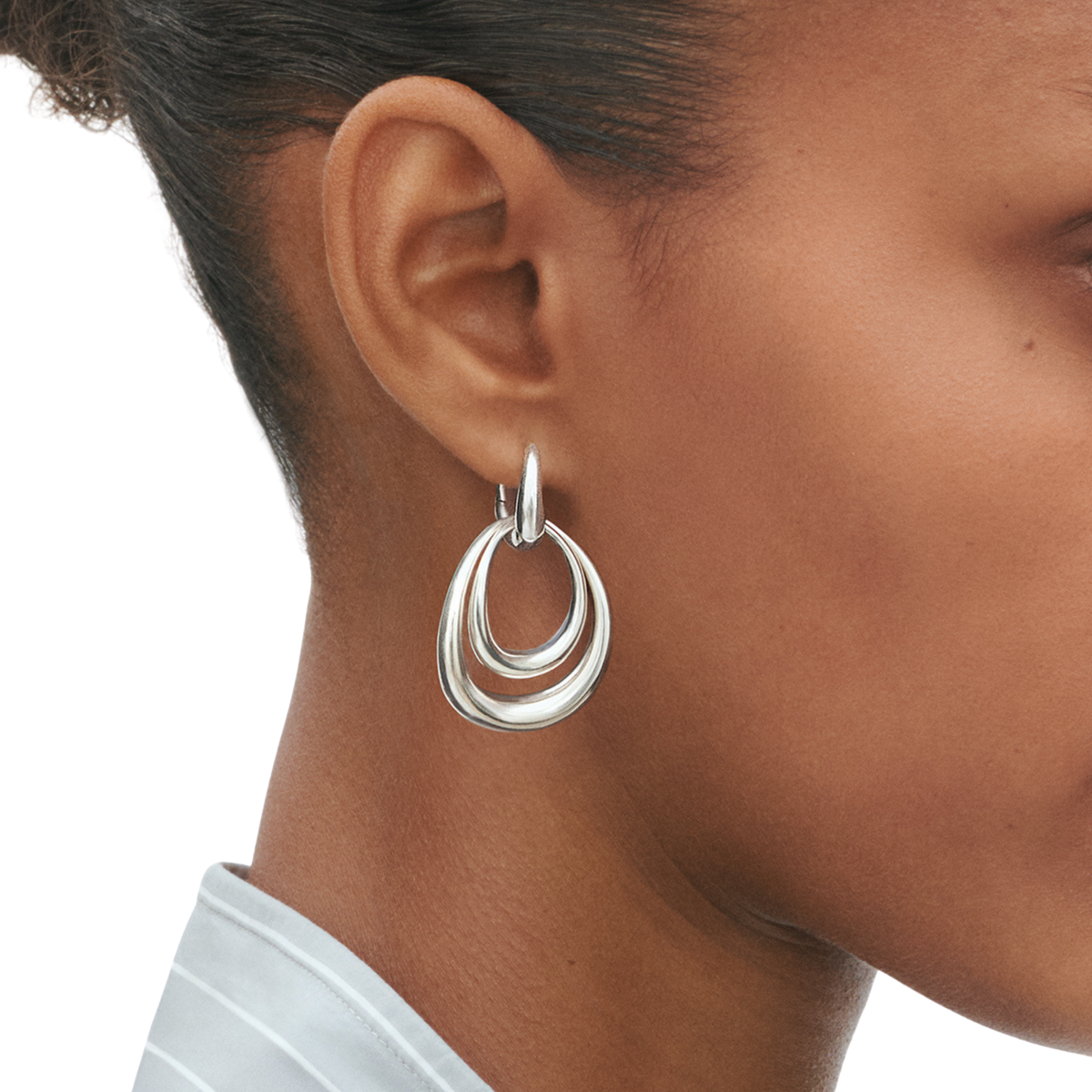 These earrings have a confident, contemporary feel that works effortlessly from day to evening. The polished silver finish catches the light as you move, while the larger design frames the face beautifully without feeling too heavy or overpowering.