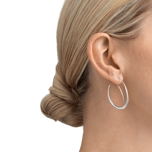With their polished silver finish and gently rounded shape, these earrings have a light, effortless feel. The double hoop design gives them a more distinctive look than traditional hoops, offering a modern update that's stylish without chasing trends.
