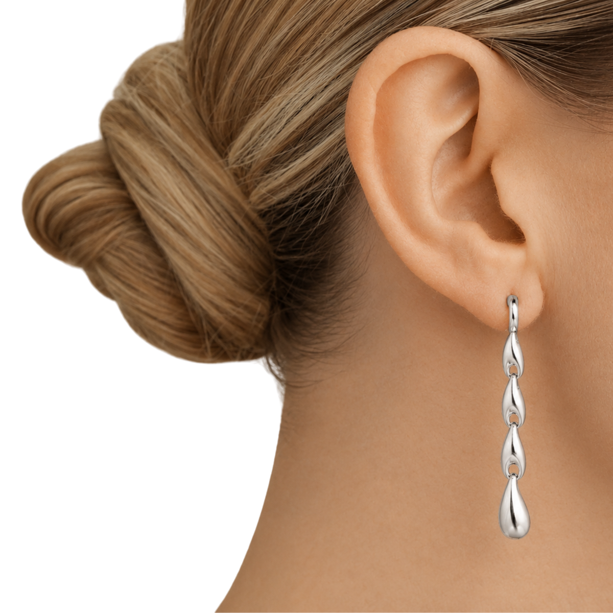 Designed with a sequence of organic silver links that flow into a teardrop-shaped drop, they bring movement, structure and a real sense of contemporary style without feeling heavy or overworked.