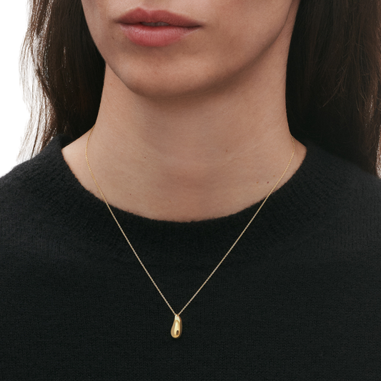 Crafted in solid 18ct yellow gold, the pendant has a soft glow that feels more elevated than the sterling silver version. The slightly irregular, organic shape keeps it from feeling too polished or formal, giving it a relaxed, contemporary edge.