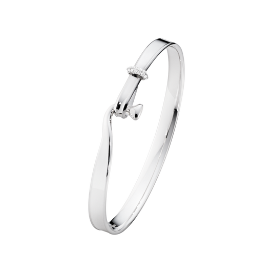 The Georg Jensen Torun Diamond Bangle proves that the smallest details often make the biggest impact. Crafted in sterling silver, its flowing open design is finished with a delicate row of 0.08ct brilliant-cut diamonds set into the clasp, adding a refined sparkle without taking away from the bangle's beautifully minimalist style.