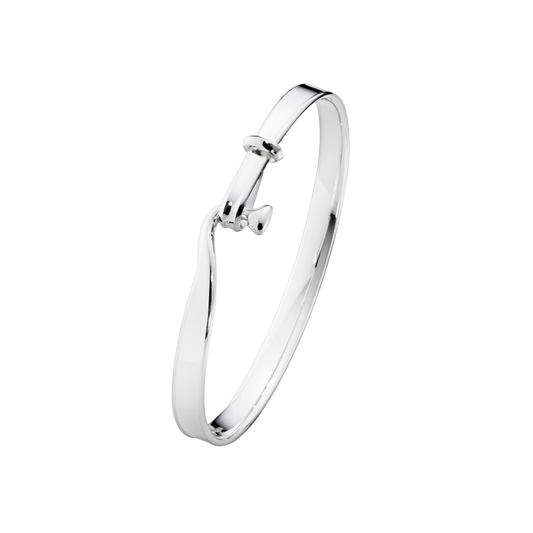 The Georg Jensen Torun Bangle is perfect worn alone for a clean, sculptural look or stacked with other bangles for a more layered style. 