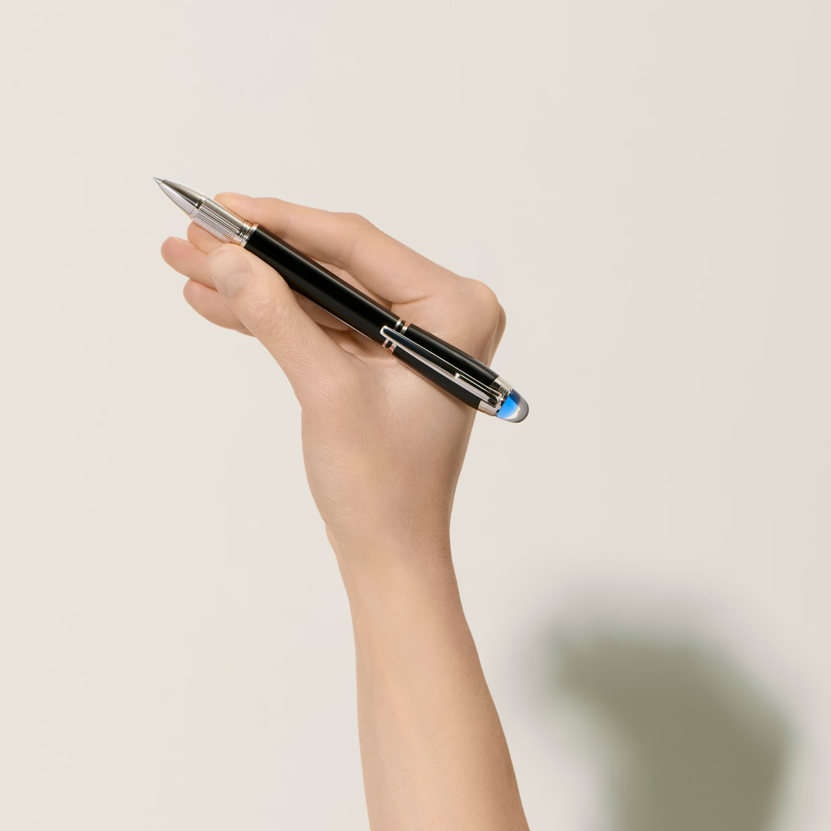 Hand holding the Montblanc StarWalker SpaceBlue fineliner pen with black precious resin barrel.