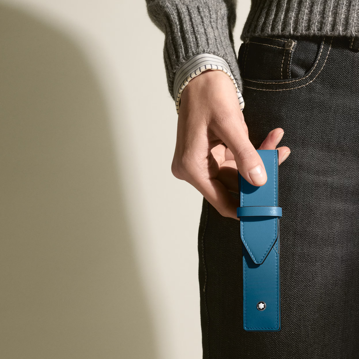 Hand holding the Montblanc Envelope 1 Pen Pouch in blue leather for everyday pen protection.