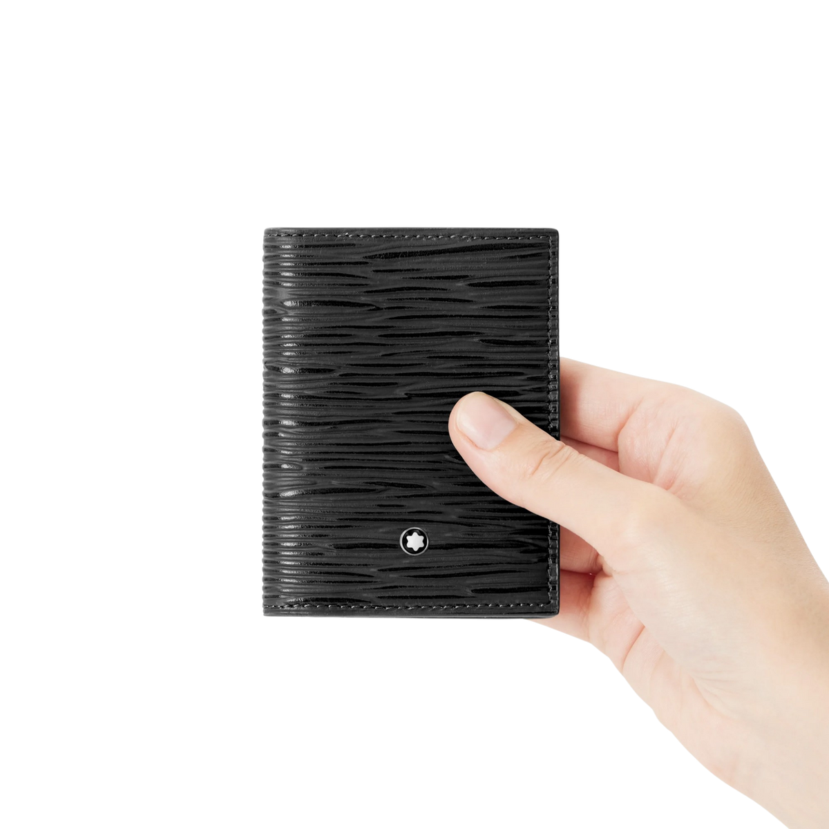 Hand holding the Montblanc black leather card holder to show its compact size.
