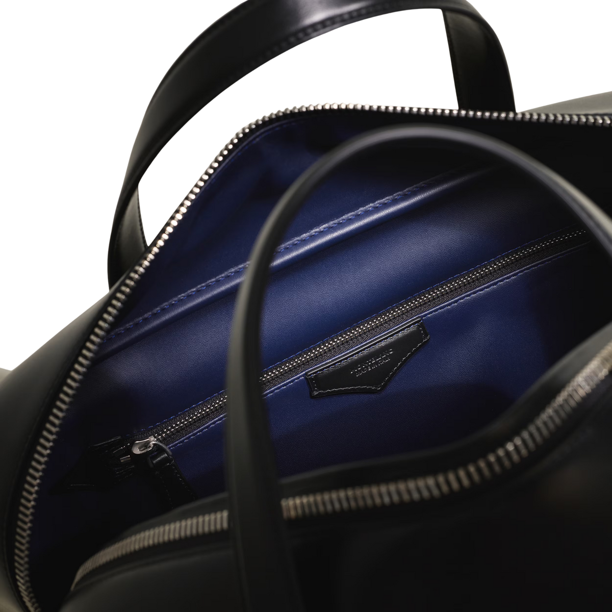 Close-up of the Montblanc Meisterstück 149 bag's blue-lined interior and zip compartment.