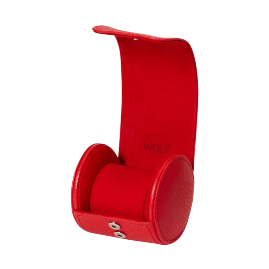 The exterior shows off smooth red vegan leather with clean stitching and a polished fastening system that keeps the roll tightly secured. The finish feels lightweight yet structured, giving it a durable, well-crafted feel without losing its soft, travel-friendly flexibility.